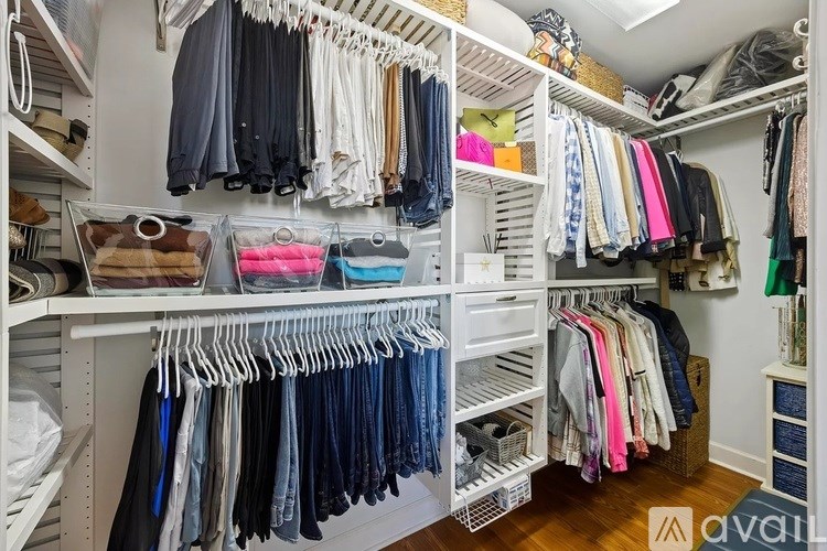 A well-organized closet with clothes on hangers and shelves.