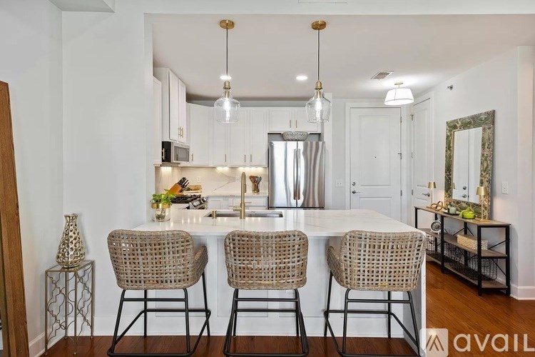 A kitchen with a table and chairs in front of it.