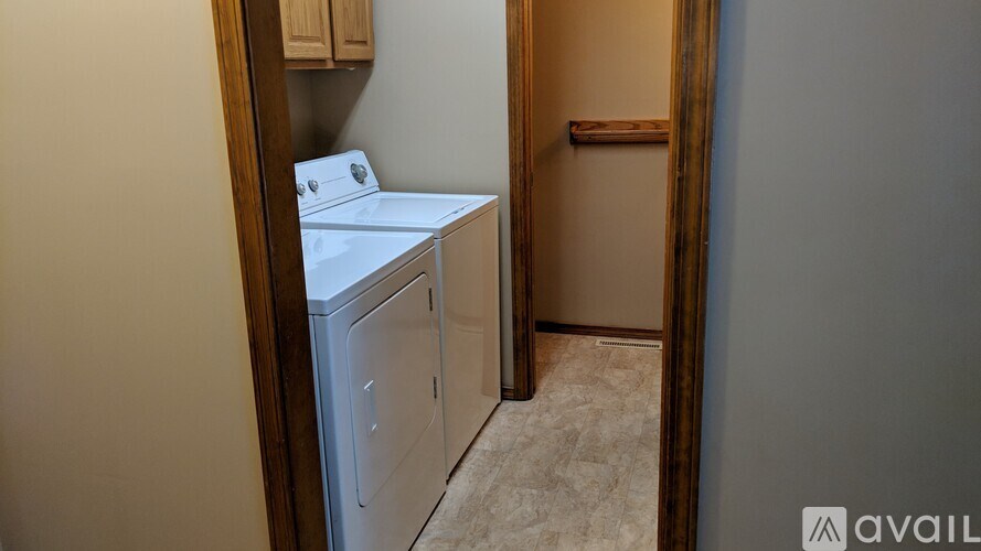 A small laundry room with a washer and dryer.