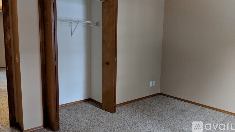 A room with a carpeted floor and a door.
