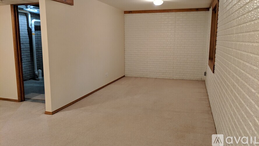 A room with white walls and a carpeted floor.