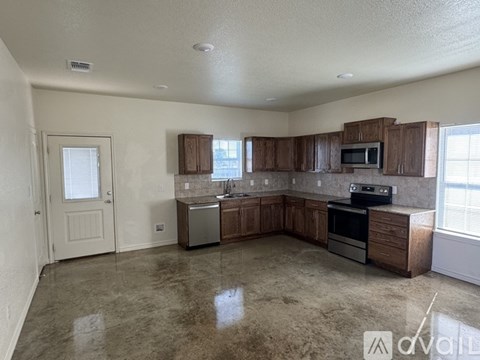 A kitchen with brown cabinets and a stainless steel dishwasher.