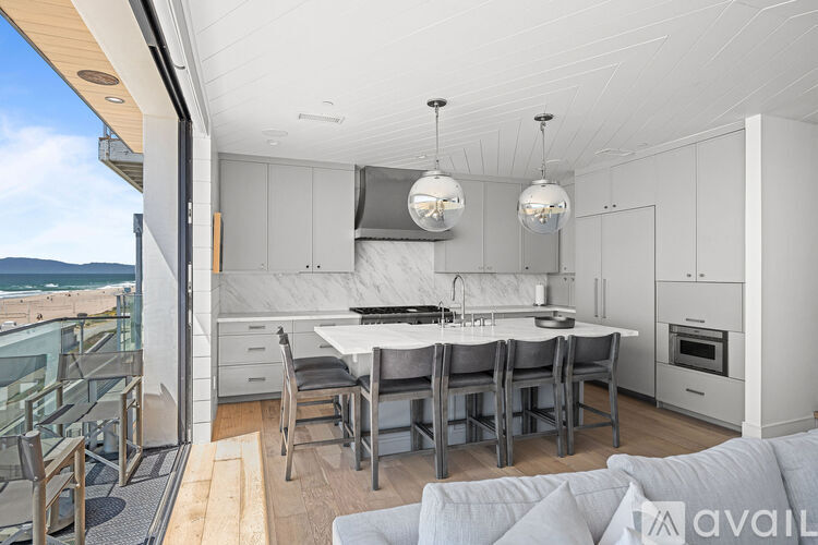 A modern kitchen with a dining table and chairs.