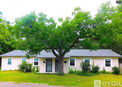 A house with a tree in front of it.