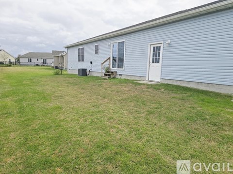 A blue house with a white door and a small porch.
