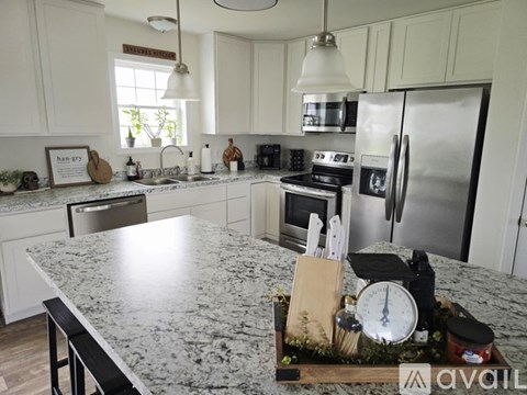 A kitchen with granite countertops and stainless steel appliances.