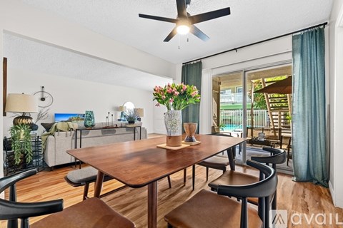 A dining room with a wooden table and chairs.