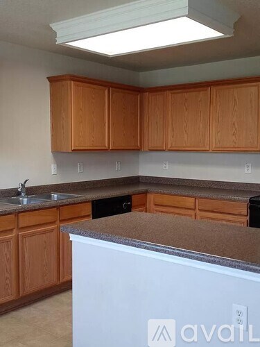 A kitchen with wooden cabinets and a white refrigerator.
