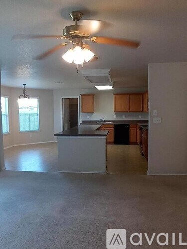 A kitchen with a fan and a counter.