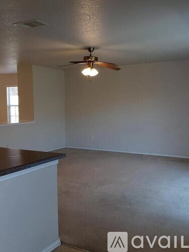 A room with a ceiling fan and a window.