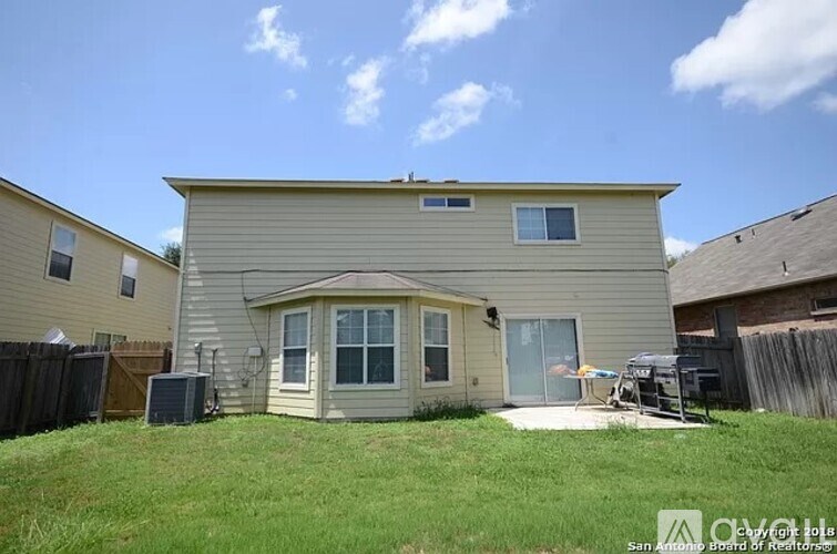 A house with a green lawn in front of it.