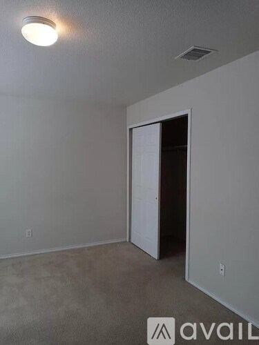 A room with a door and a light on the ceiling.