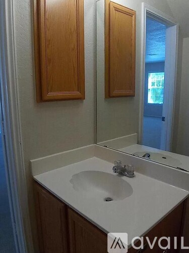 A bathroom with a sink and a mirror.