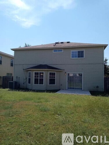 A house with a brown roof and a white garage door.