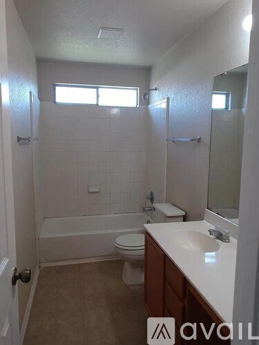 A bathroom with a toilet, sink, and bathtub.