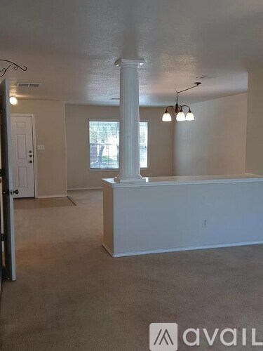 A room with a white column and a window.