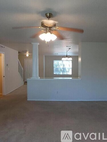 A room with a fan and a window.