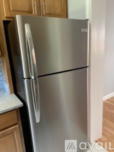 A stainless steel refrigerator in a kitchen.