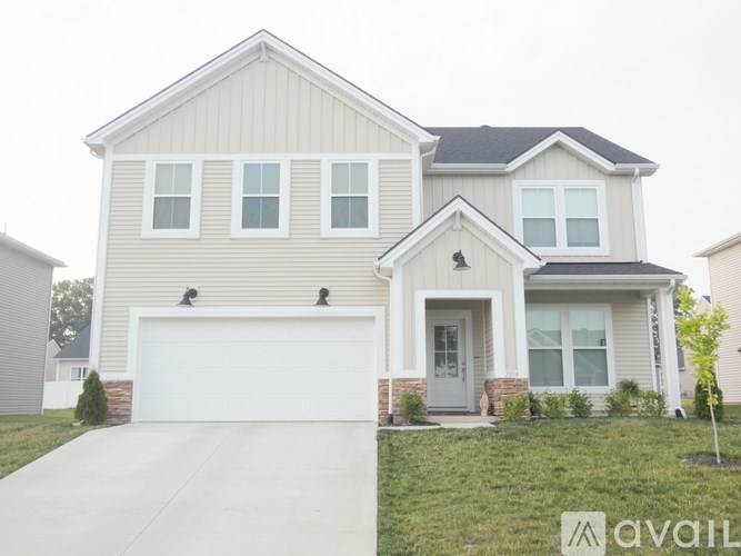 A two-story house with a garage and a front door.