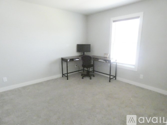 A room with a desk and a computer monitor.