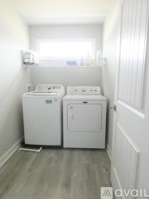 A small laundry room with a washer and dryer.