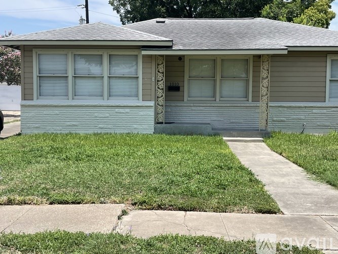 A house with a grey roof and a grey garage door.