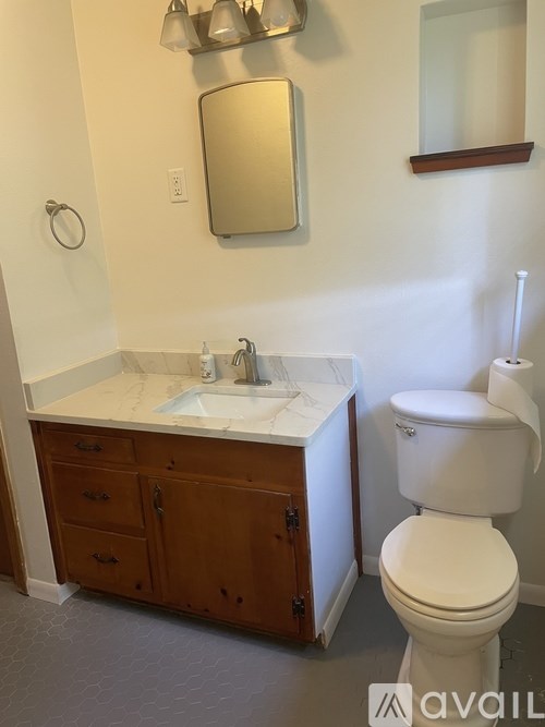 A white toilet sits next to a sink in a bathroom.