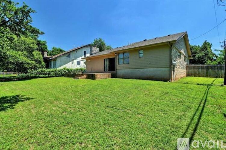 A house with a large lawn is for sale.