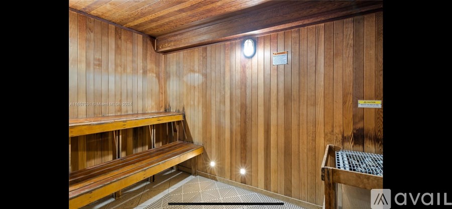 A wooden room with a bench and a sign that says "available".