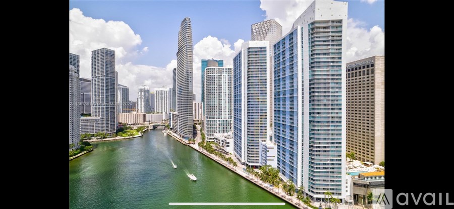 A cityscape with tall buildings and a river running through it.