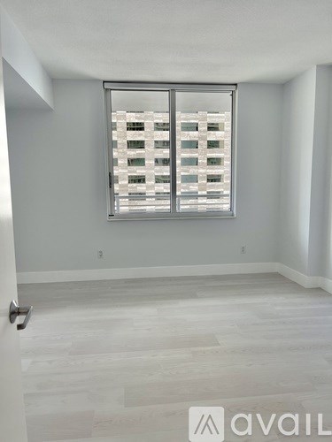 A room with a large window and a sliding door.