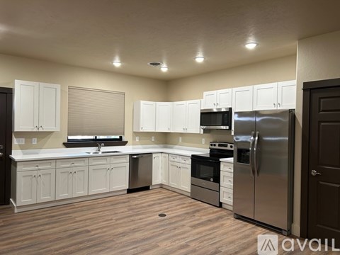 A kitchen with white cabinets and stainless steel appliances.