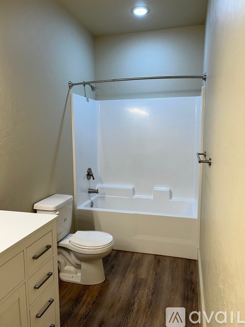 A white bathroom with a toilet, sink, and bathtub.