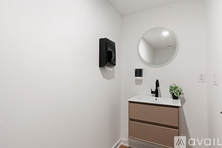 A bathroom with a sink and mirror.