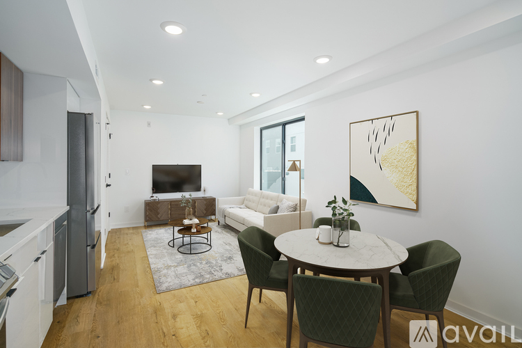 A modern living room with a dining table and chairs.