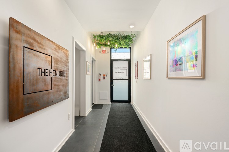 A hallway with a sign that says "The Hendrix" on the wall.