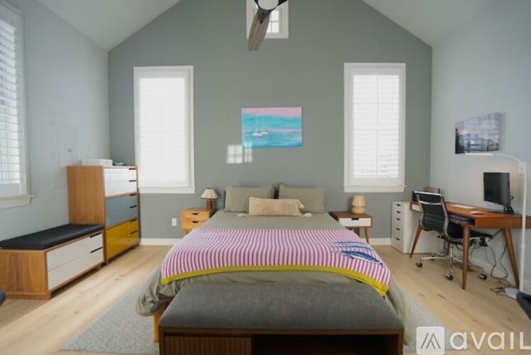 A room with a ceiling fan and a door leading to another room.