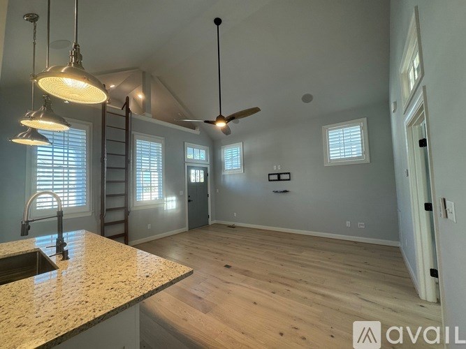 A kitchen with a granite countertop and a ceiling fan.
