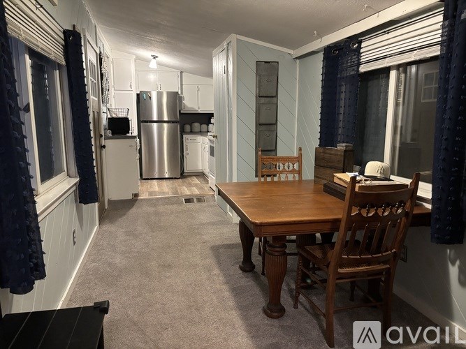 A kitchen with a table and chairs in the middle of the room.