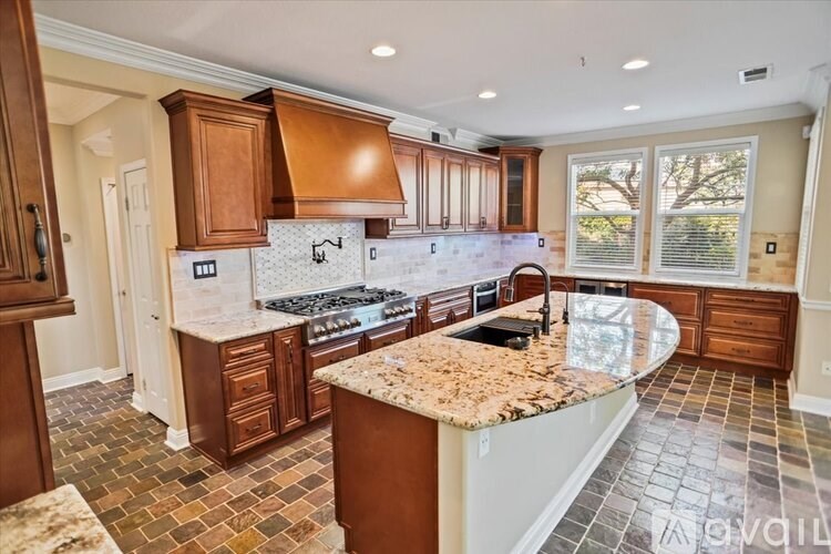 A kitchen with a granite countertop and tile flooring.