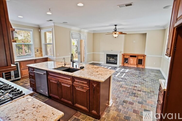 A kitchen with a marble countertop and a tile floor.