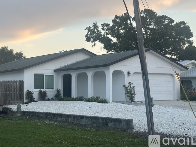 A bathroom with a marble floor and a window.