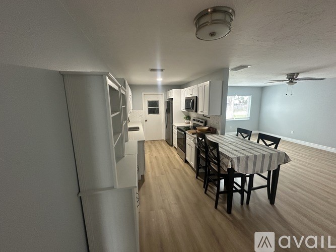 A kitchen with a dining table and chairs is available for rent.