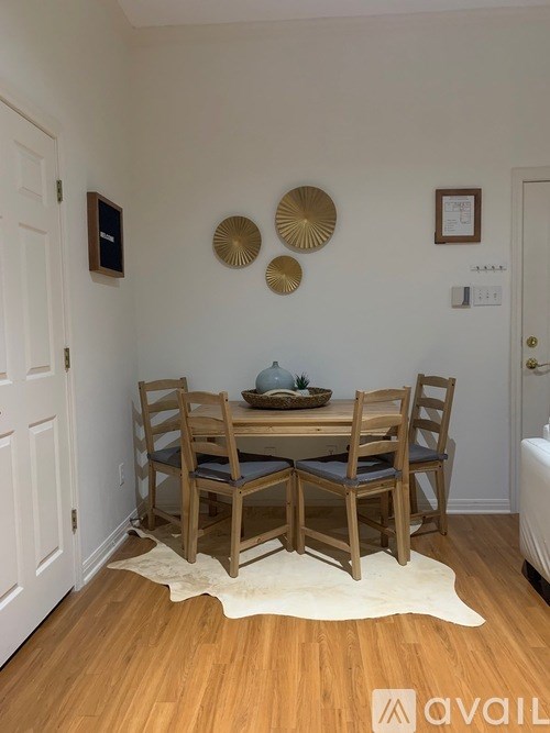 A dining room with a wooden table and chairs.