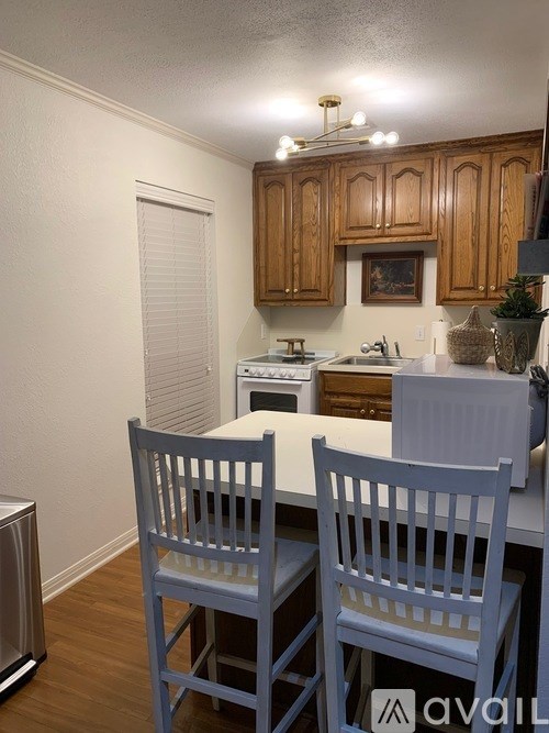 A kitchen with wooden cabinets and a white countertop.