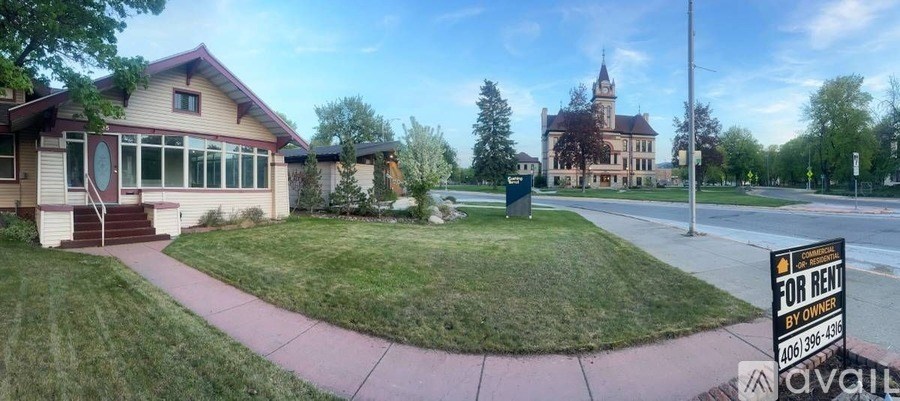 A house with a "For Rent" sign in front of it.