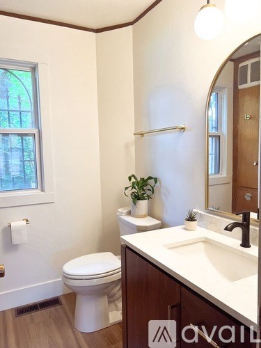 A white toilet sits next to a sink in a bathroom.