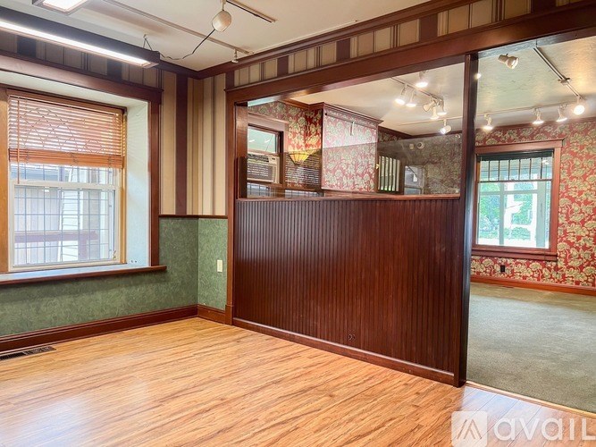 A room with wooden floors and a green wall.
