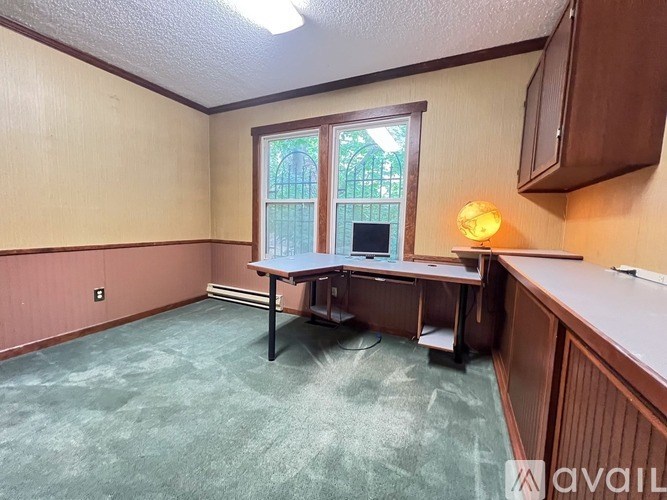 A room with a desk and a window.