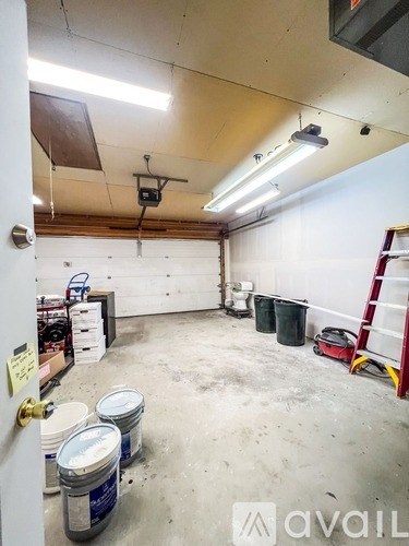 A room with a white wall and a ladder.